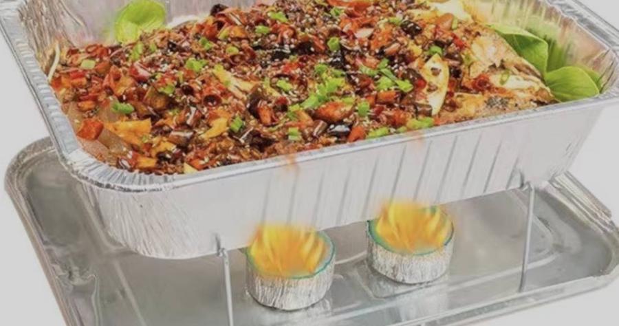 Aluminum steam table pan with catering food on a serving rack